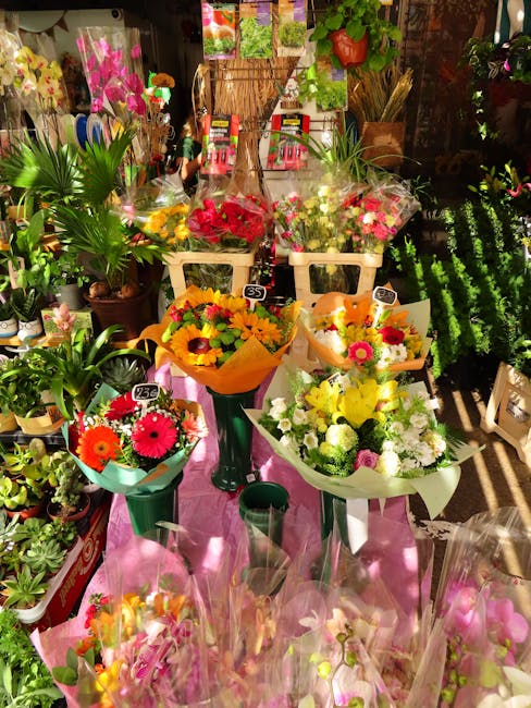 A display of vibrant floral arrangements and bouquets at floristbigginhill.co.uk, featuring a variety of fresh flowers including bright pink gerbera daisies, yellow and orange sunflowers, white chrysa