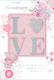 This anniversary card feels like a gentle celebration of enduring romance, crafted with the same care a florist would use when arranging a delicate pastel bouquet for a Biggin Hill couple. The design is centred around the word LOVE, elegantly spelled in raised, blush-pink glitter that adds texture and a soft, refined shimmer. The letter O is transformed into a shimmering heart, textured in silver, giving the focal point extra depth and a touch of modern charm. The surface appears slightly embossed, inviting touch in the same way a velvety rose petal does when you receive a fresh delivery at home near Biggin Hill Common. Surrounding this central motif, clusters of illustrated blooms in blush, mauve, and soft rose-pink float across the card. Their edges are soft and almost watercolour-like, with fine, flowing lines suggesting petals just beginning to unfurl. These blossoms, paired with slender stems and gentle swirls, evoke the grace of an English spring garden, echoing the calm of nearby green spaces on a mild day. Tiny flourishes-small petals, graceful curls, and subtle butterfly silhouettes-add a sense of motion and whimsy, as if a light breeze is moving through the floral border. The background remains a muted pink, allowing the soft silvers and whites to stand out without overwhelming the eye. Written in an understated, flowing script are the phrases On Our Anniversary and I love you today and always, their elegant curves harmonising with the swirling vines. The overall composition feels as tender as a whispered promise, making this card an ideal keepsake to accompany anniversary flowers delivered across Biggin Hill.
